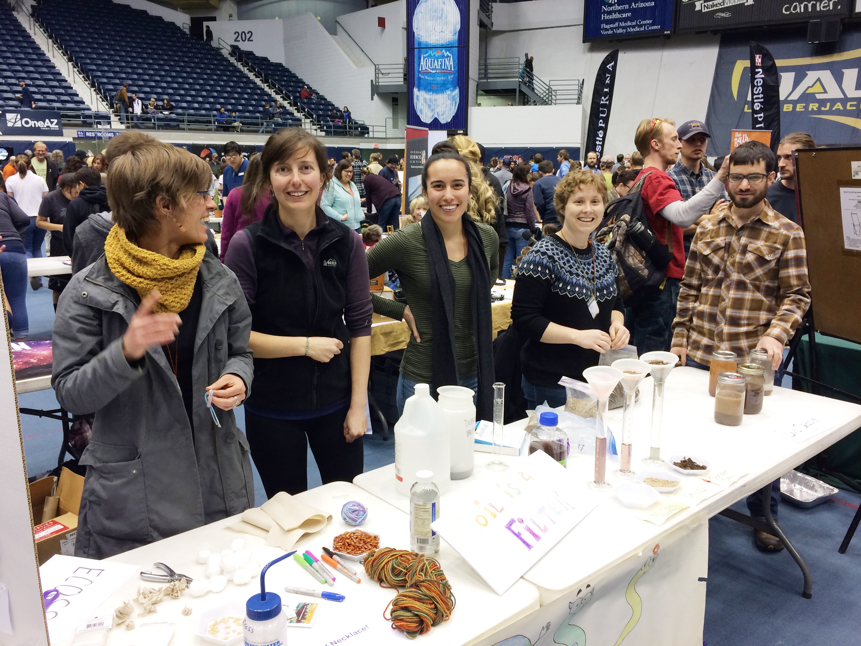 Ecoss members at a demonstration table of soil jars and samples at the Flagstaff STEM Celebration