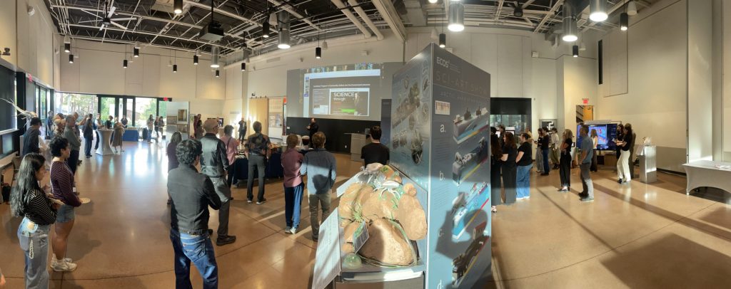 The NAU International Pavilion during the show: guests among the art stations under the big screen