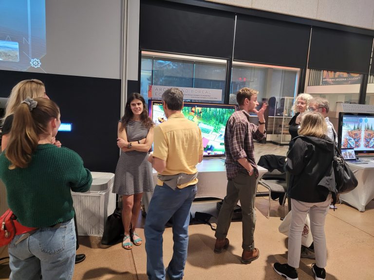 A presenter with guests among the stations